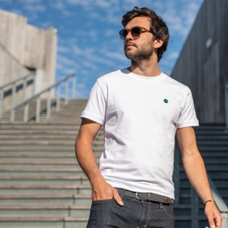 Blue Cedar mens Eau De Tpillete cologne placed on rock with a sprig of cedar