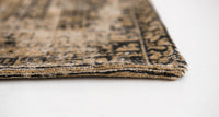 Corner edge detail of warm beige distressed rug