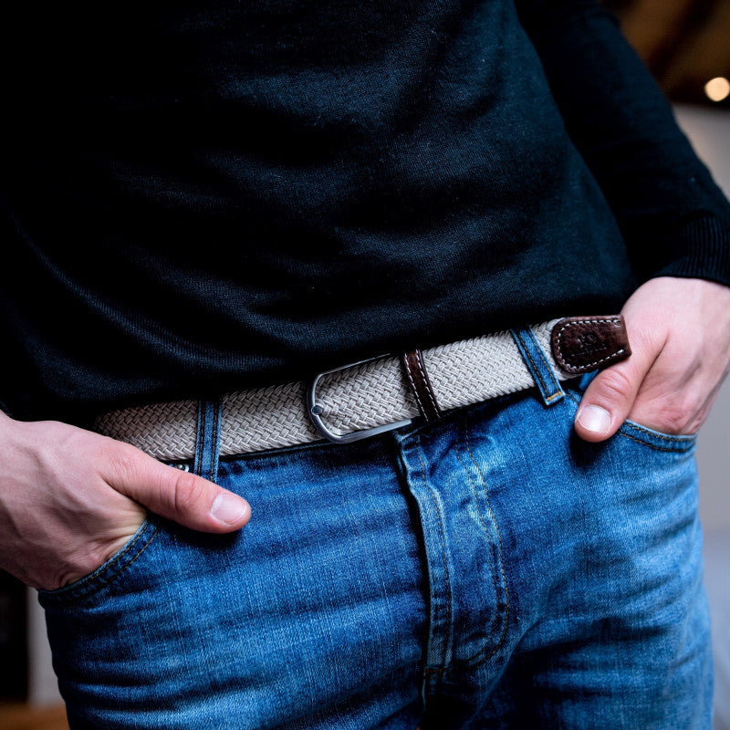 Braided Belt Sandy Beige with brown leather finish on model in blue trousers